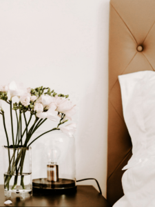 Bedside table with flowers an light